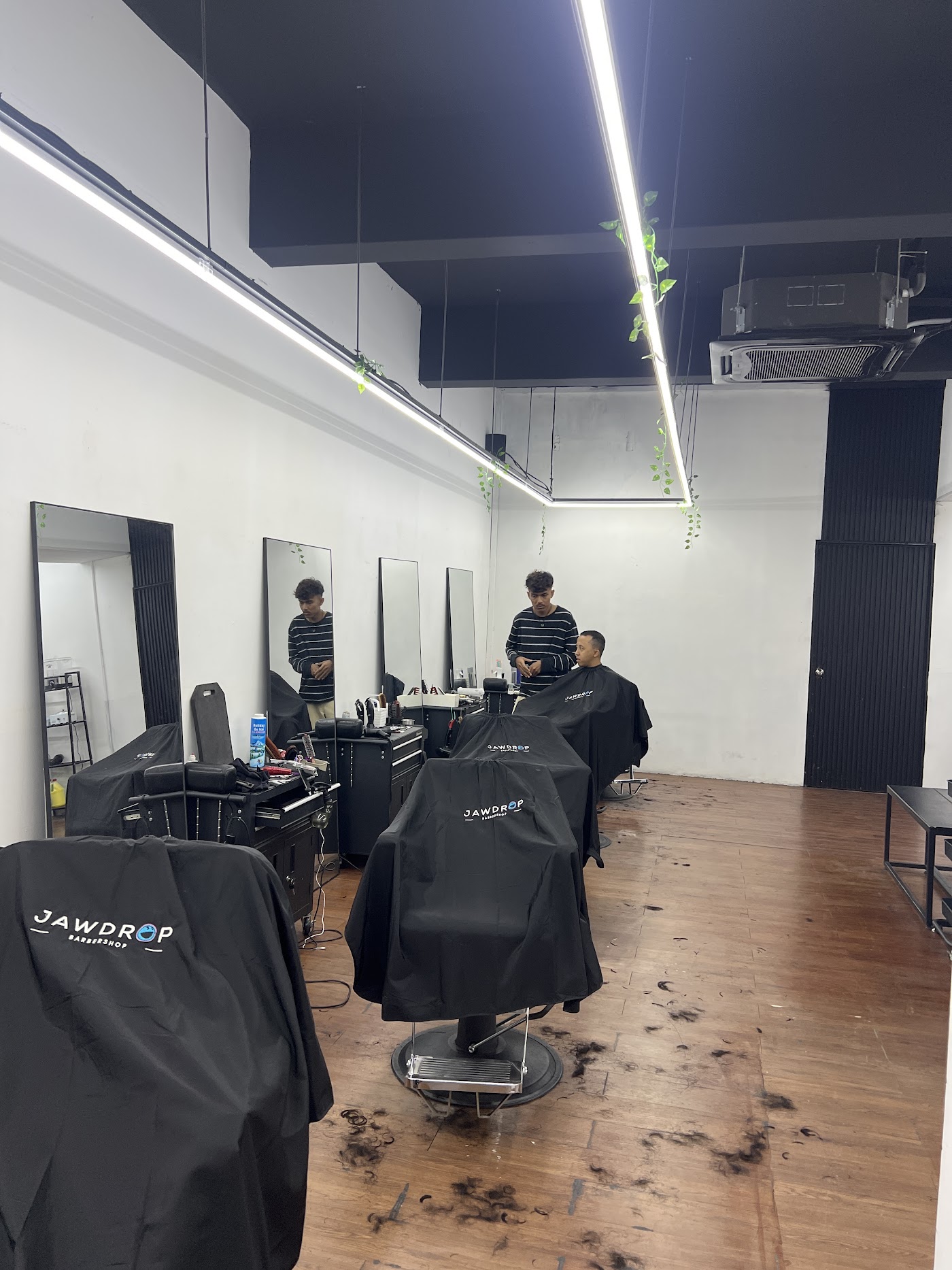 Jawdrop styling chairs with branded capes and mirrors