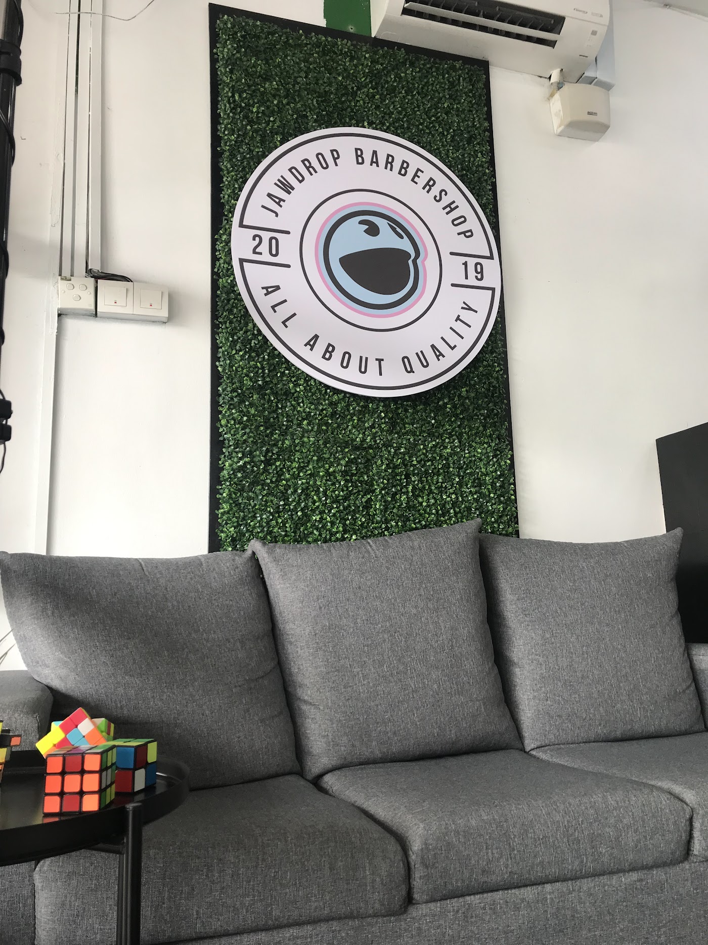 Branded JAWDROP logo wall above the lounge sofa