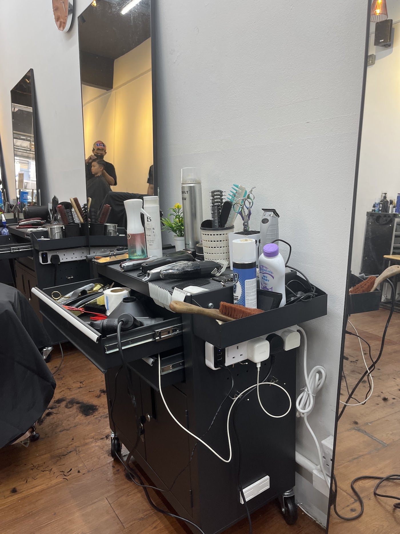 Jawdrop barber's station laid out with tools and mirror